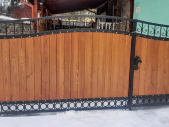 Brama wjazdowa, dwuskrzydłowa, uchylna, kuta z&nbsp;drewnem BU 104